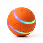 BorkBall Disco orange interactive dog ball with glowing rainbow LED stripes and paw print emboss on white background