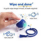 Hand wiping the BorkBall Nub clean with a soft cloth, rope popped off for easy care