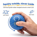 Hand squeezing the BorkBall Zoom showing its flexible pet safe rubber shell