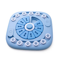 Blue plastic dog puzzle toy with sliding paw print covers and bone shaped flip lids